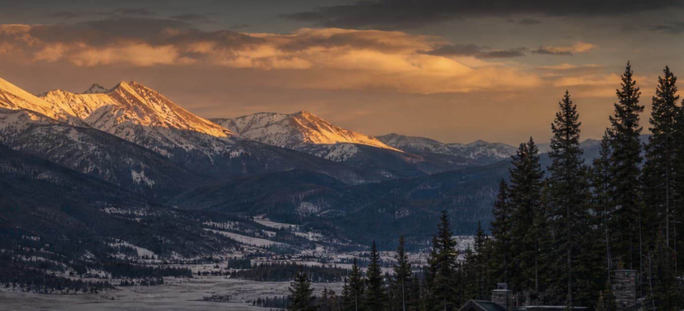 Sunrise alpenglow on the Continental Divide above the Fraser Valley in Grand County, Colorado